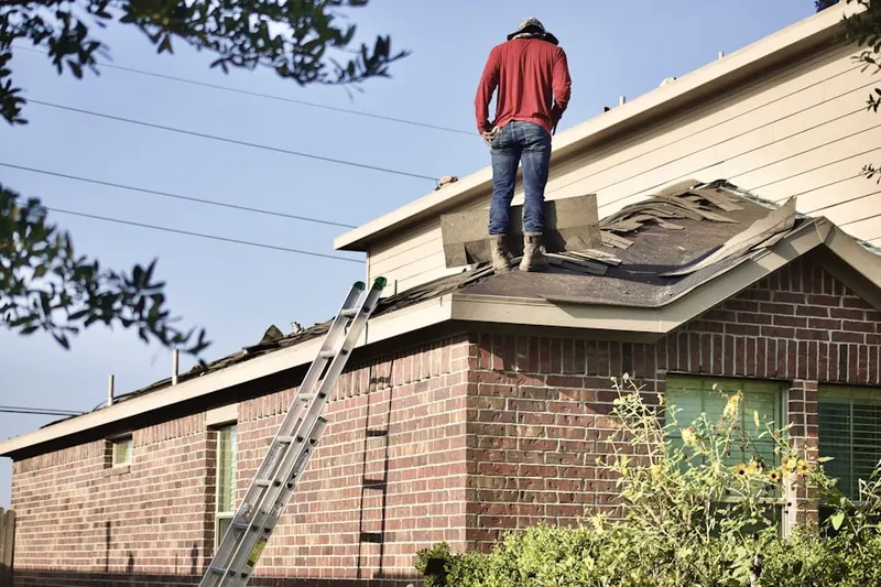 Professional roofer working on a residential roof in Providence View